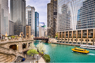 Busy cityscape of skyscrapers and bridges along the Chicago River.