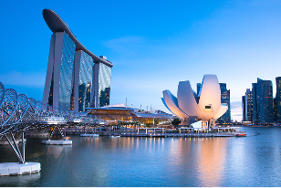 Iconic Singapore skyline with Marina Bay Sands hotel and ArtScience Museum at sunrise.